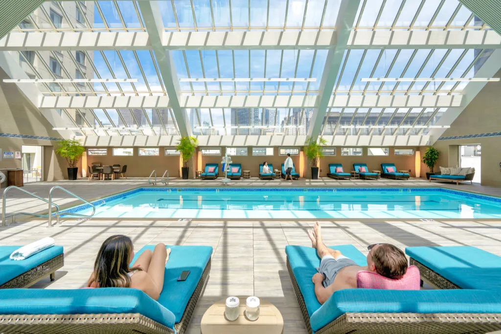 Skylit indoor hotel pool with city skyline views — hospitality & commercial photography by Wasim Muklashy, Hotel Nikko San Francisco