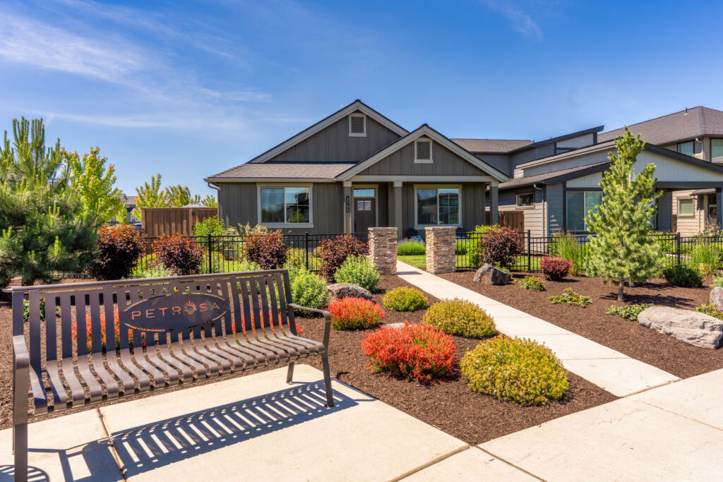 Craftsman model home with landscaped walkway and Petrosa community bench in Bend, Oregon