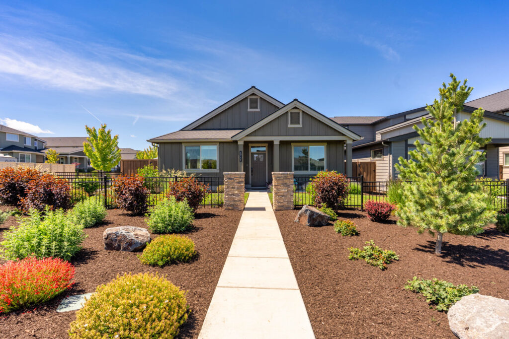 Modern farmhouse front exterior with xeriscaped path in Redmond, Oregon