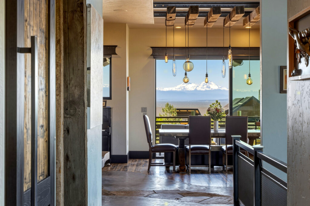 Dining area with pendant lights framing a Three Sisters mountain view