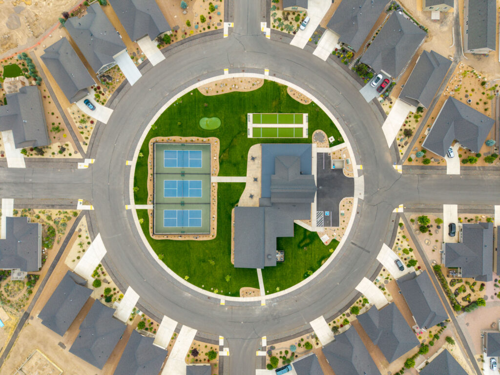 Overhead drone view of a neighborhood roundabout park and sport courts