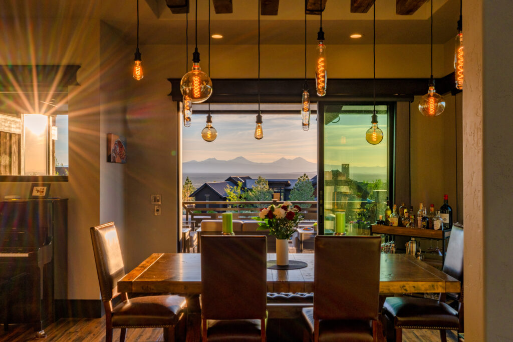 Dining space with pendant lights framing a distant mountain view